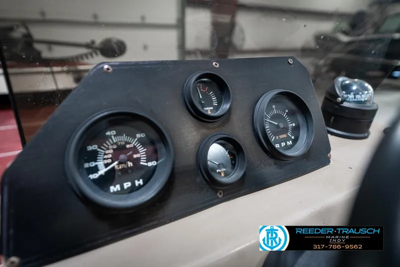 Slide: The Image of Dashboard of a 1997 Lund 1700 Pro Angler boat with speedometer and RPM gauges. - 32