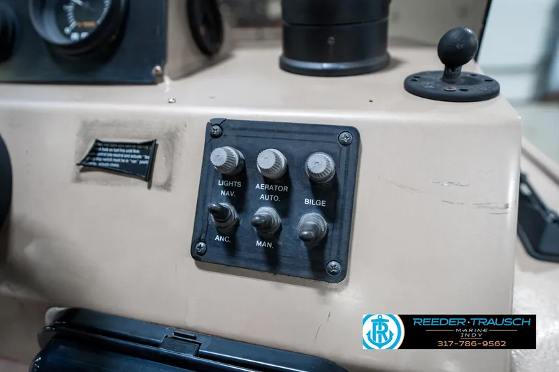 Slide: The Image of Control panel of a 1997 Lund 1700 Pro Angler boat with switches and dials. - 33