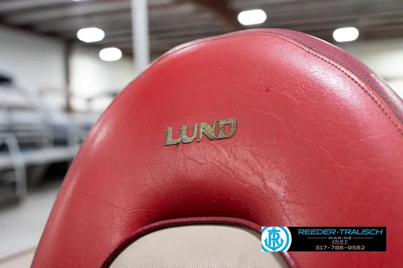 Slide: The Image of Red leather seat with "Lund" logo, 1997 Lund 1700 Pro Angler boat, indoor setting. - 37