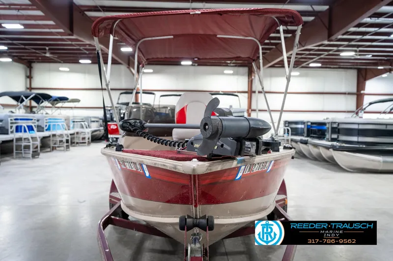 Slide: The Image of 1997 Lund 1700 Pro Angler boat in showroom with trolling motor and canopy. - 4