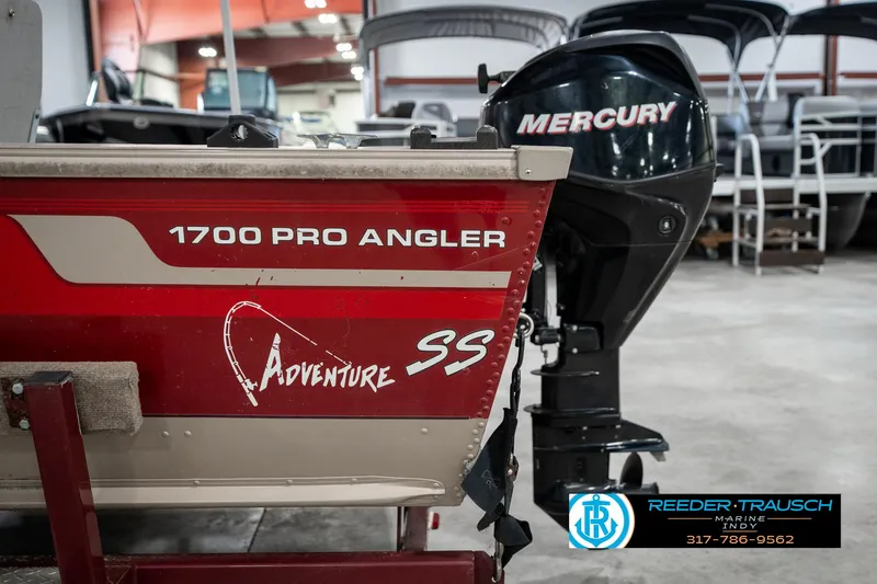 Slide: The Image of 1997 Lund 1700 Pro Angler boat with Mercury engine in showroom. - 42
