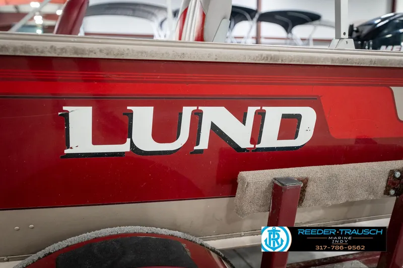 Slide: The Image of Red 1997 Lund 1700 Pro Angler boat with visible logo and dealership contact information. - 47
