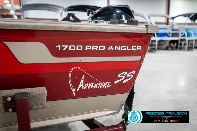Slide: The Image of 1997 Lund 1700 Pro Angler boat in showroom, featuring Adventure SS graphics. - 48