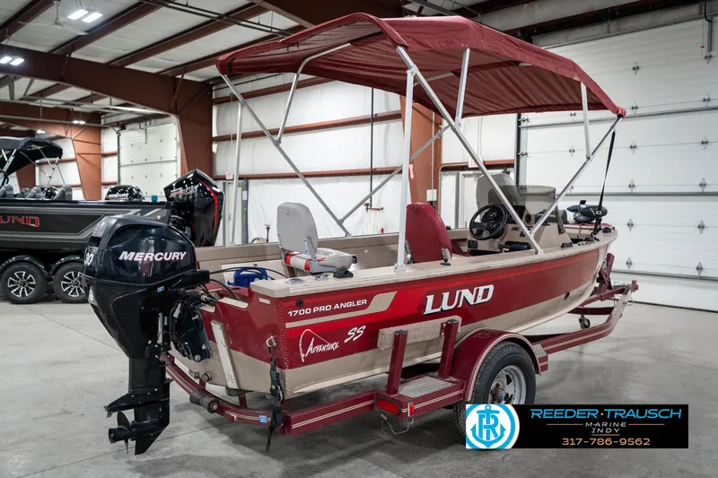 Slide: The Image of 1997 Lund 1700 Pro Angler boat with Mercury engine in a showroom. - 7