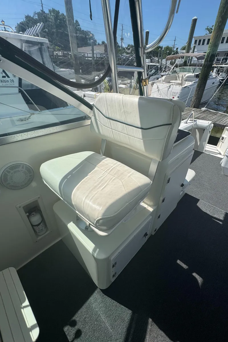 Slide: The Image of Captain's chair on 2002 Pursuit 3000 Express boat, docked in marina. - 14
