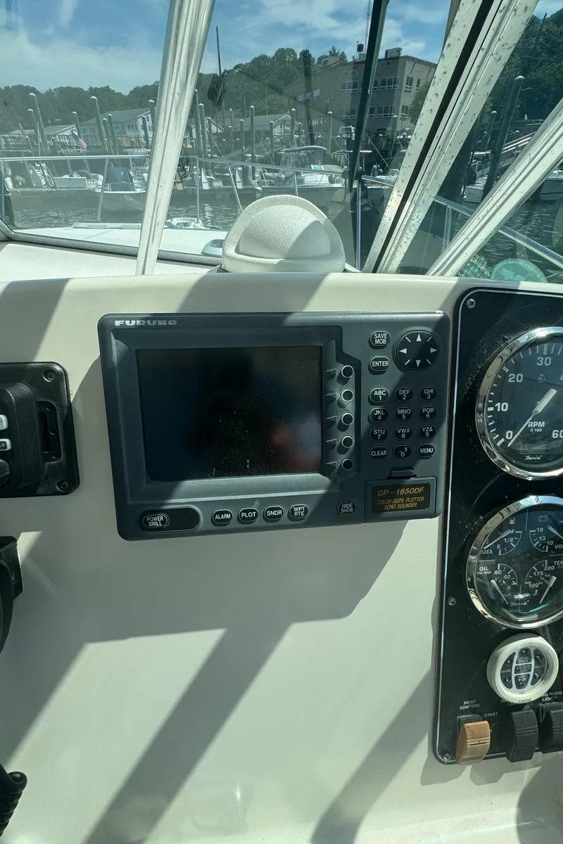 Slide: The Image of Dashboard of a 2002 Pursuit 3000 Express boat with navigation equipment. - 15
