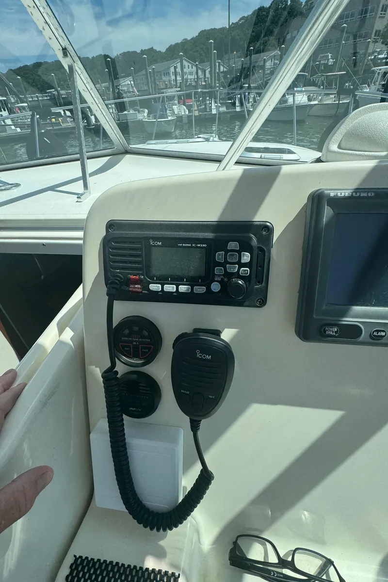 Slide: The Image of Control panel of a 2002 Pursuit 3000 Express boat with radio and navigation equipment. - 16