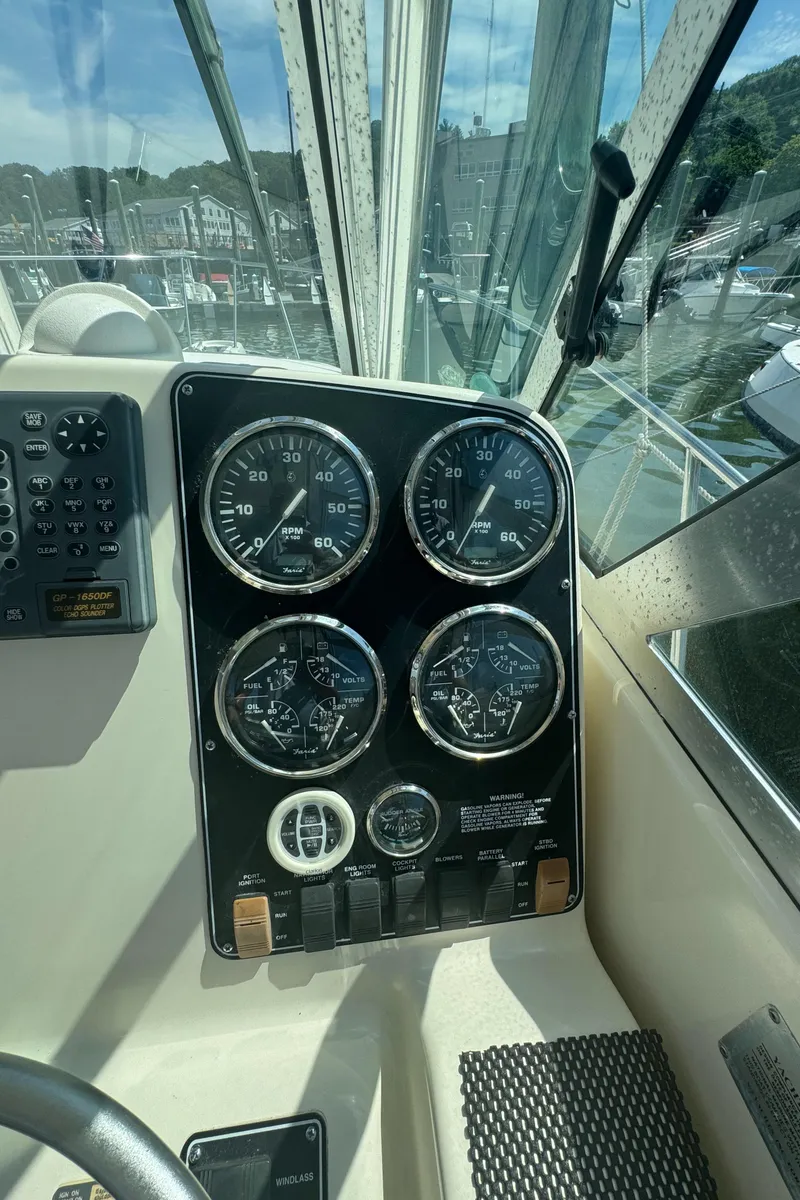 Slide: The Image of Dashboard of a 2002 Pursuit 3000 Express boat with gauges and controls. - 17