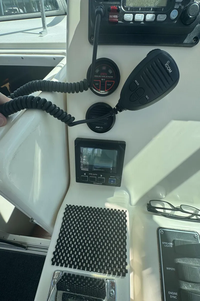 Slide: The Image of Control panel of a 2002 Pursuit 3000 Express boat with radio and navigation equipment. - 18