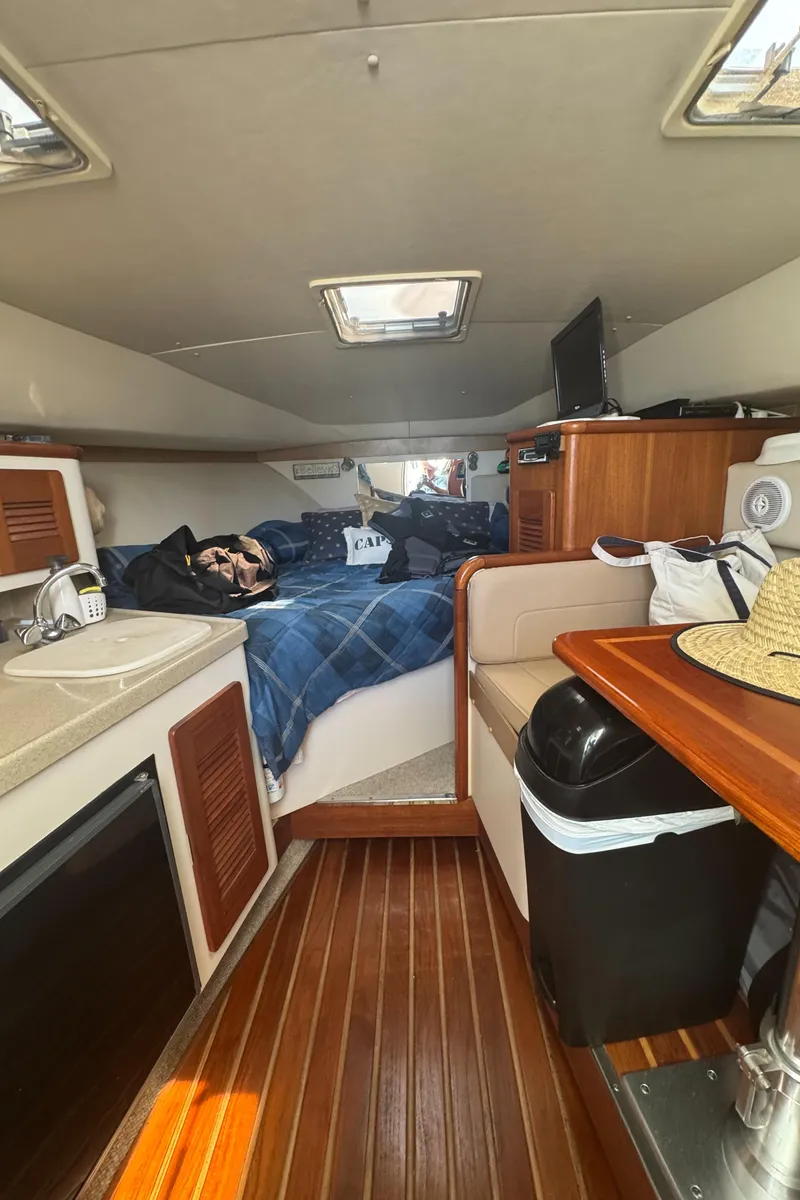 Slide: The Image of Interior of 2002 Pursuit 3000 Express boat with cozy cabin and wooden flooring. - 20