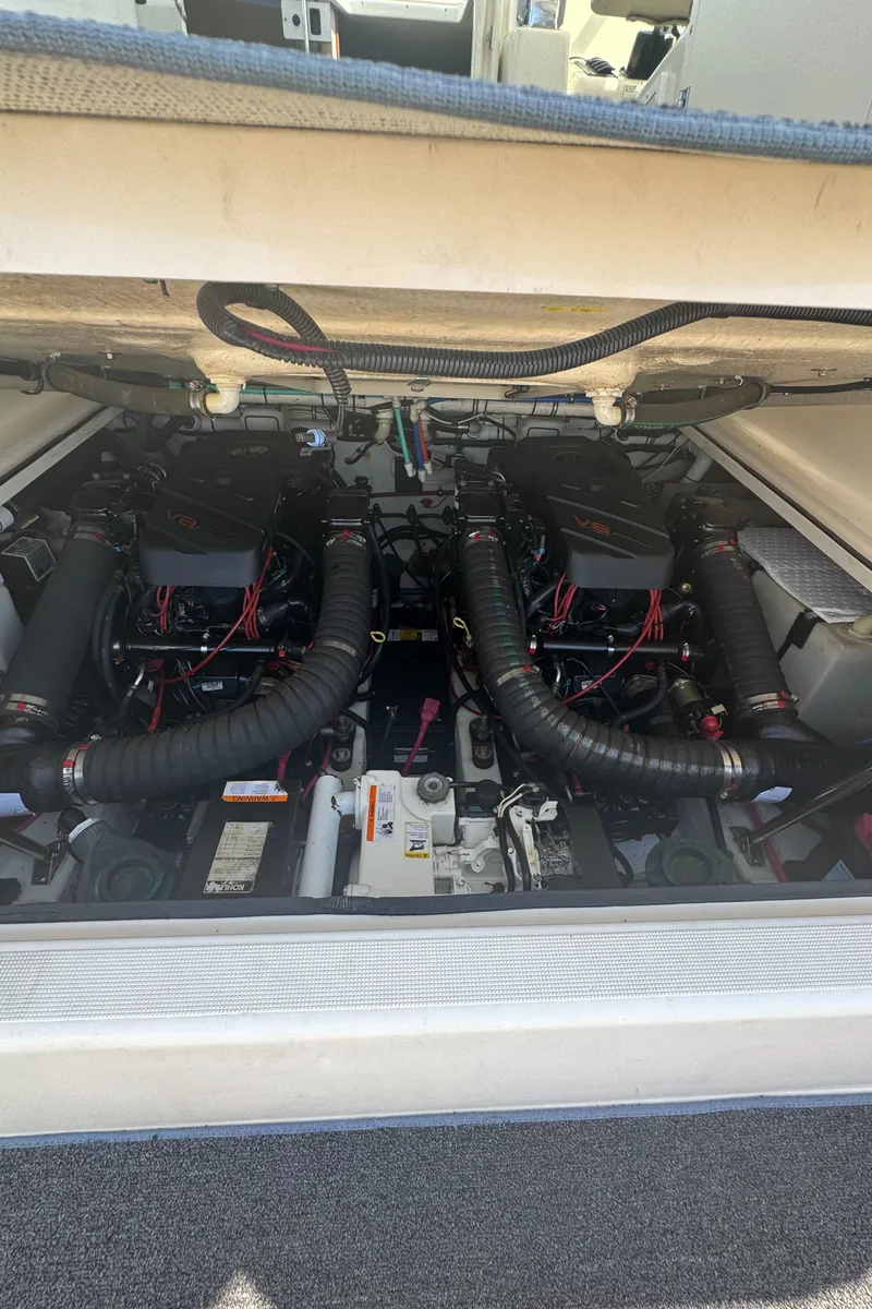 Slide: The Image of Engine compartment of a 2002 Pursuit 3000 Express boat, showcasing dual engines. - 31