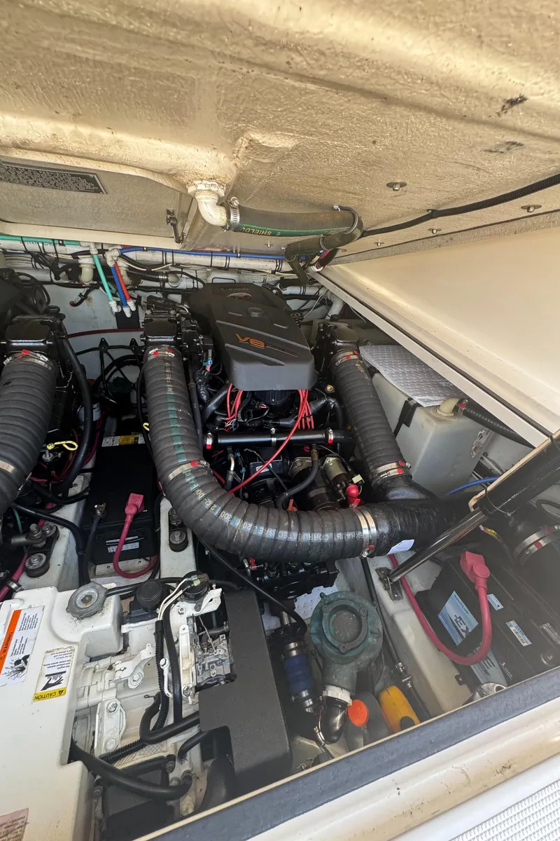 Slide: The Image of Engine compartment of a 2002 Pursuit 3000 Express boat, featuring a V8 engine. - 33