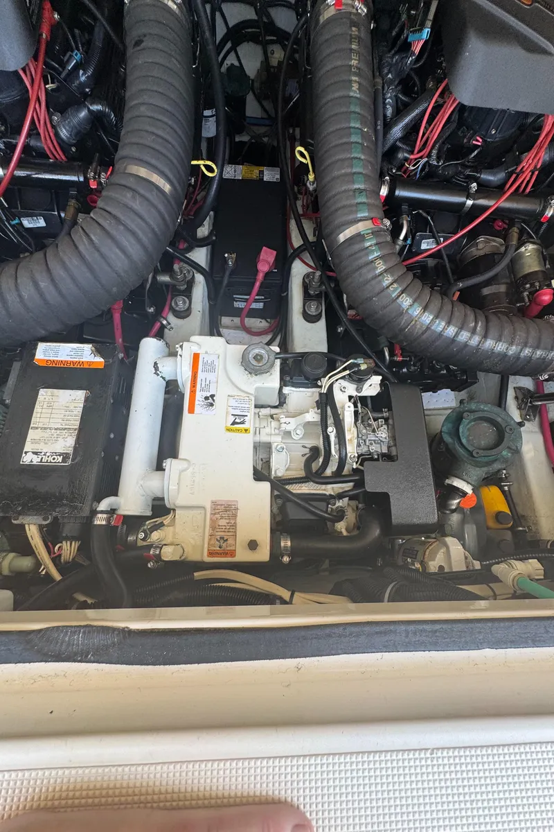 Slide: The Image of Engine compartment of a 2002 Pursuit 3000 Express boat, showing mechanical components and wiring. - 34