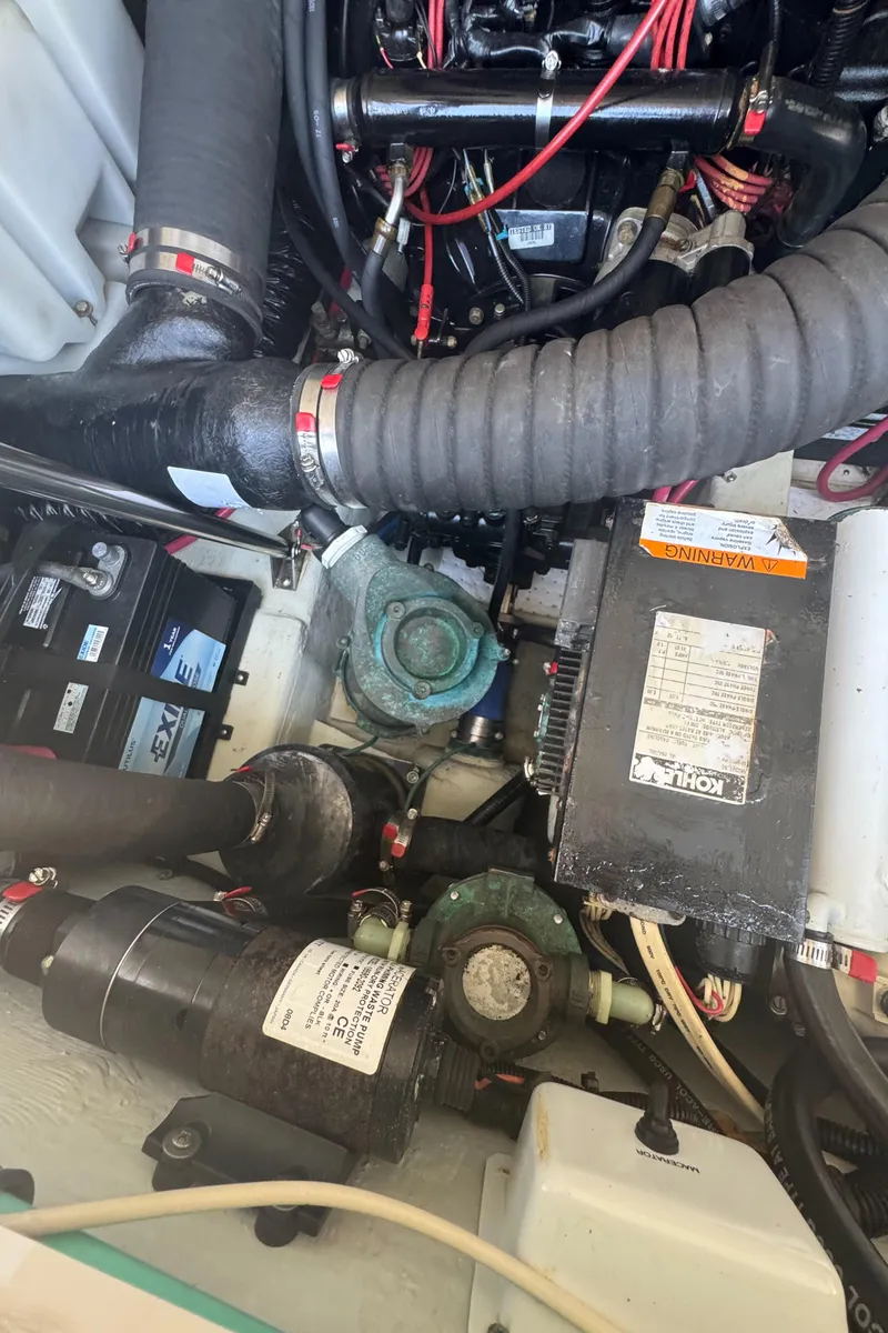 Slide: The Image of Engine compartment of a 2002 Pursuit 3000 Express boat, showing various mechanical components. - 36