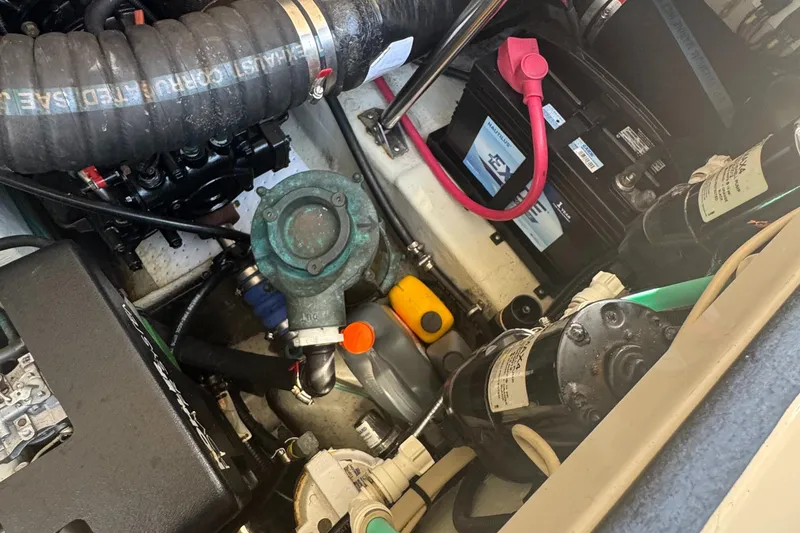Slide: The Image of Engine compartment of a 2002 Pursuit 3000 Express boat, showing various mechanical components. - 38