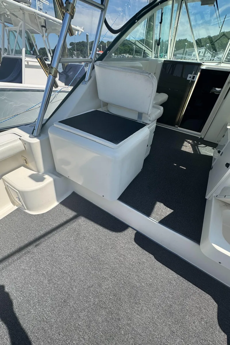 Slide: The Image of 2002 Pursuit 3000 Express boat interior with seating and carpeted floor. - 40