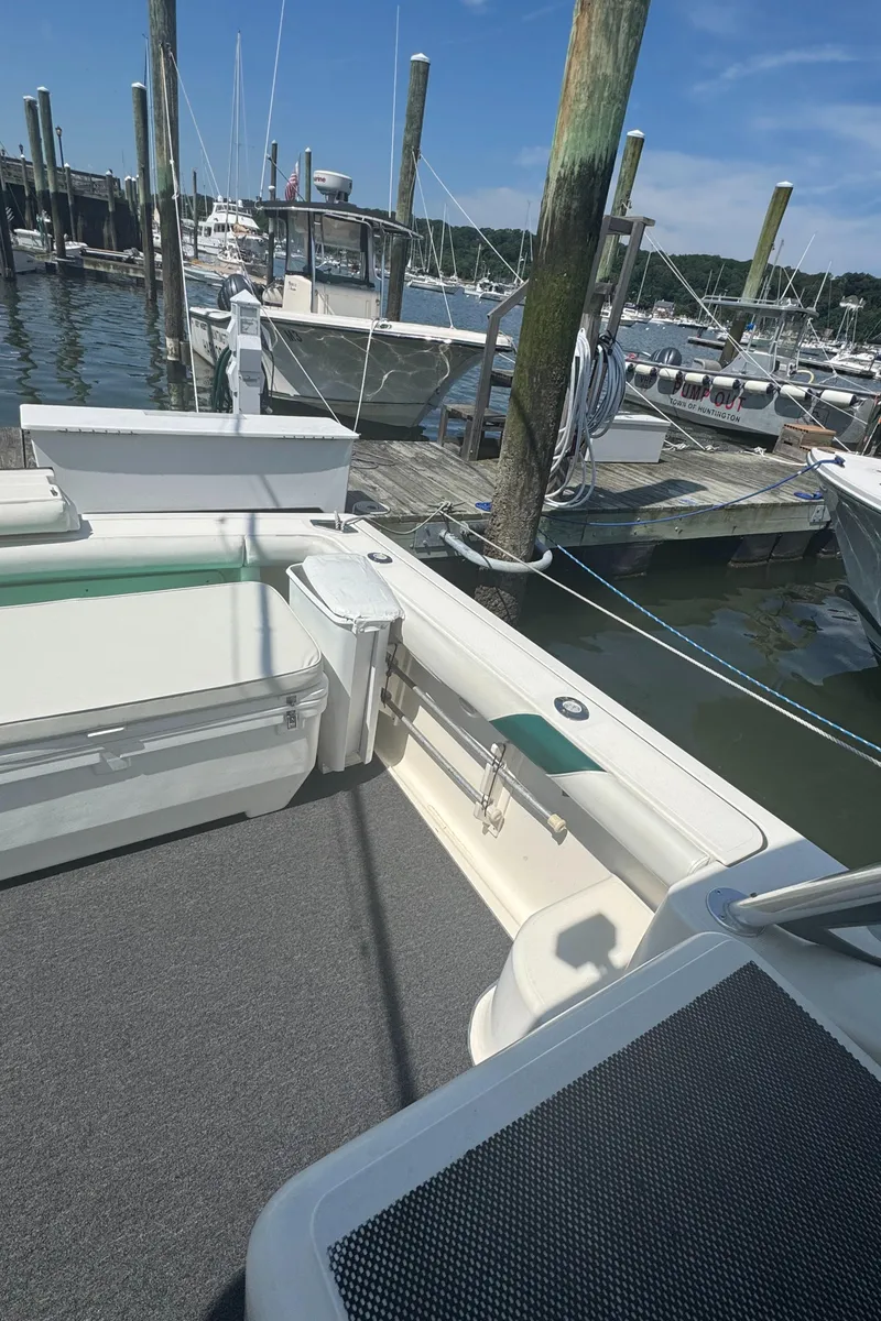 Slide: The Image of 2002 Pursuit 3000 Express boat docked at marina under clear blue sky. - 8