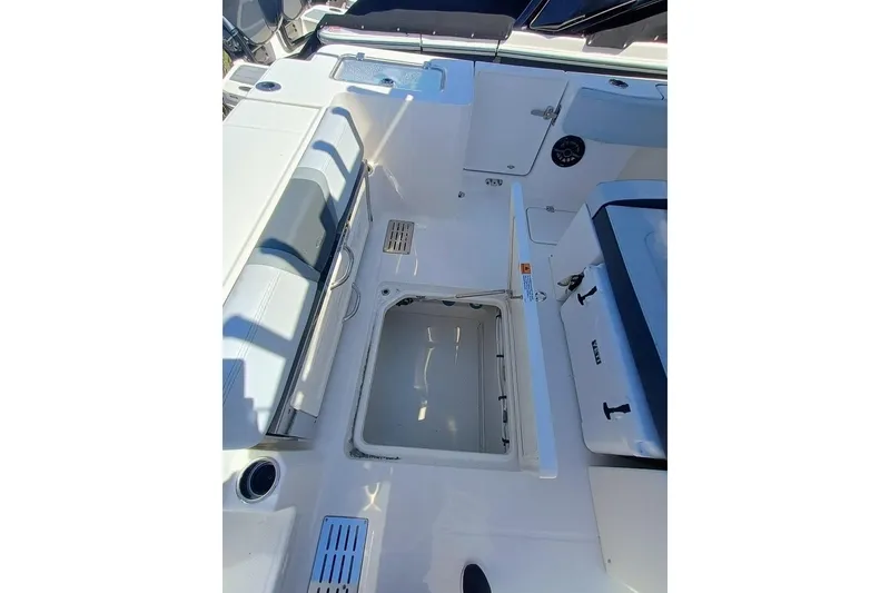 Slide: The Image of 2025 Robalo R300 Center Console boat interior with open storage compartment. - 11