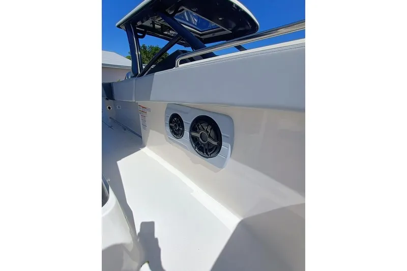 Slide: The Image of 2025 Robalo R300 Center Console boat with sleek design and built-in speakers. - 12