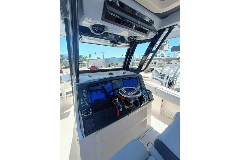 Slide: The Image of 2025 Robalo R300 Center Console boat dashboard with modern navigation equipment. - 17