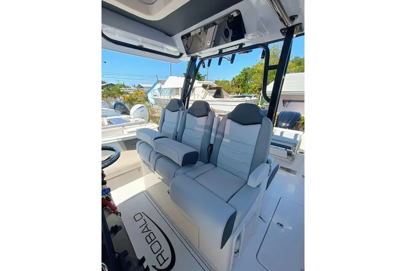 Slide: The Image of 2025 Robalo R300 Center Console boat interior with modern seating and sleek design. - 19
