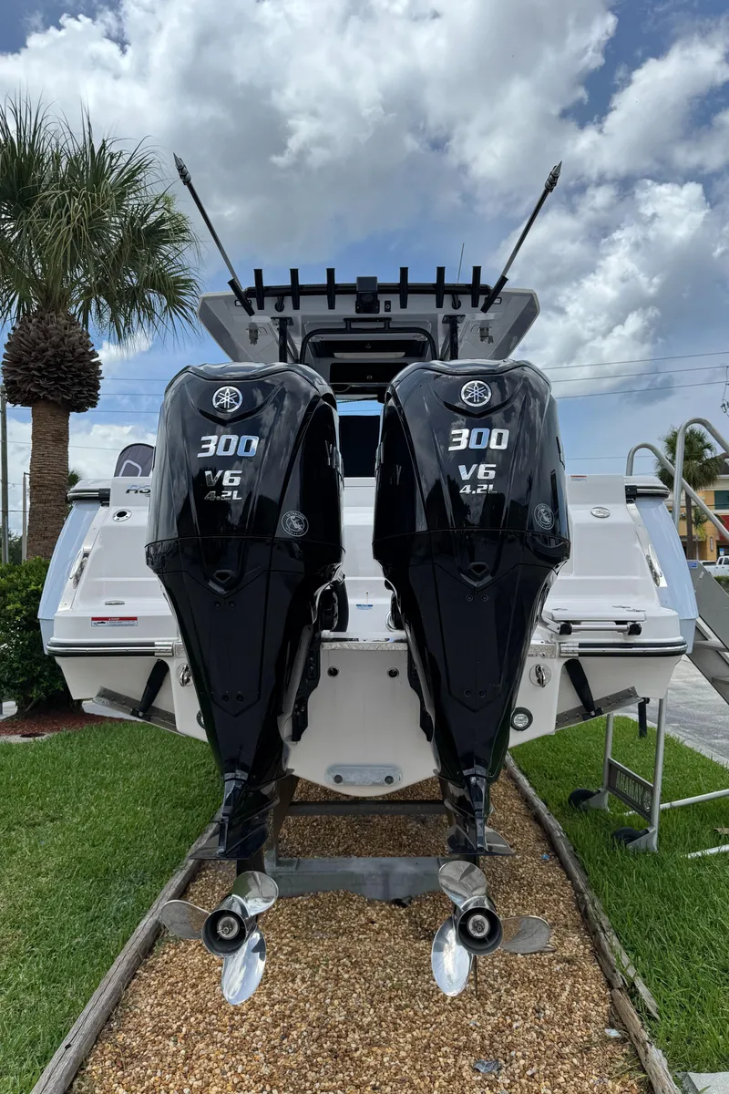 Slide: The Image of 2025 Robalo R300 Center Console with twin 300 V6 engines, displayed outdoors. - 3