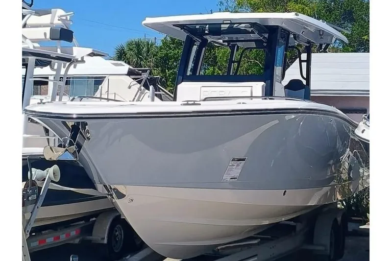 Slide: The Image of 2025 Robalo R300 Center Console boat on trailer, sleek design, outdoor setting. - 5