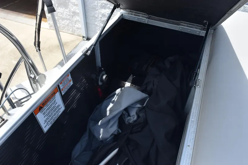Slide: The Image of Open storage compartment of 2020 Bennington SX 20 SSX boat with equipment inside. - 14