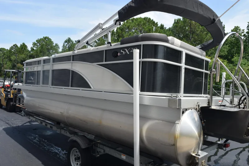 Slide: The Image of 2020 Bennington SX 20 SSX pontoon boat on trailer, parked outdoors. - 6