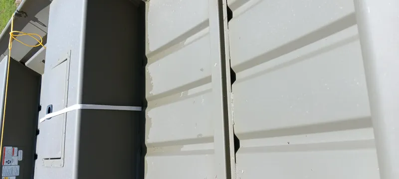 Slide: The Image of Tracker 1542 JON boat interior, 2026 model, featuring storage compartment and safety equipment. - 2