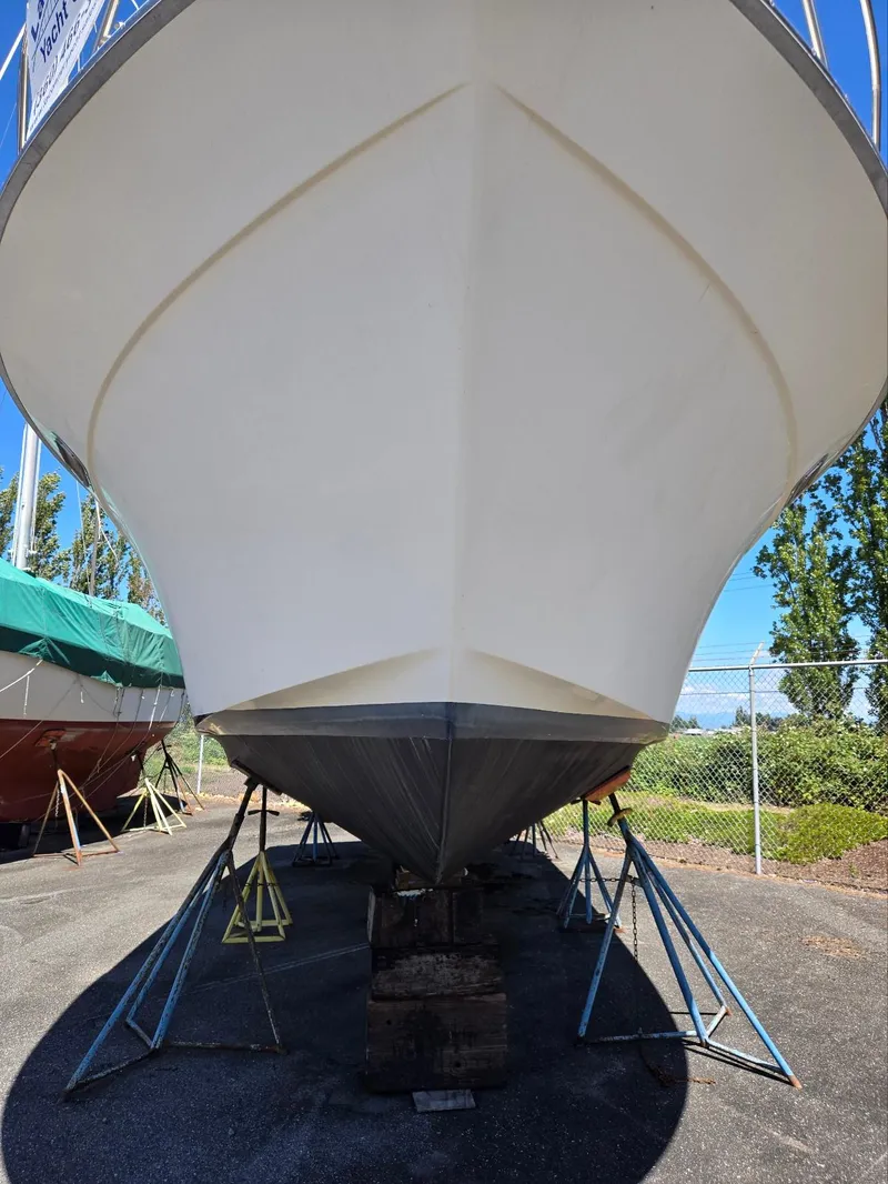 Slide: The Image of 1990 Tollycraft Sport Sedan boat on stands, viewed from the front. - 11