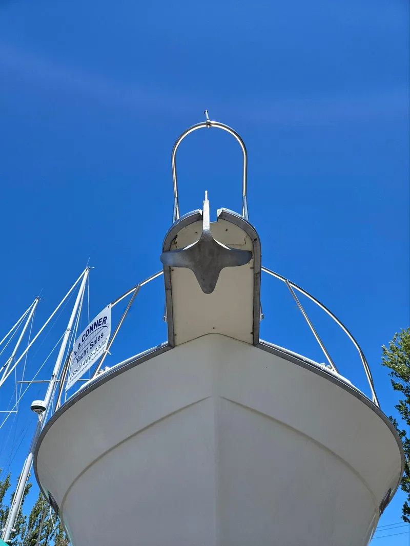 Slide: The Image of 1990 Tollycraft Sport Sedan boat under clear blue sky. - 12