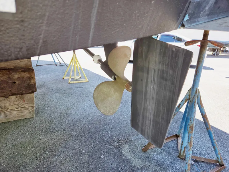 Slide: The Image of 1990 Tollycraft Sport Sedan propeller and rudder on dry dock. - 13