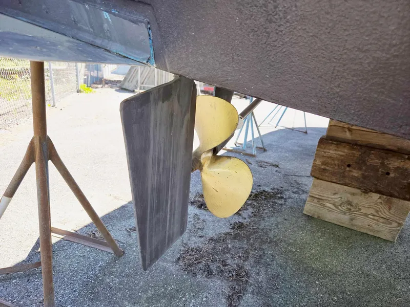 Slide: The Image of 1990 Tollycraft Sport Sedan propeller and rudder on dry dock. - 14