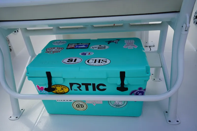 Slide: The Image of Turquoise RTIC cooler with stickers on a 2021 Robalo R230 Center Console boat. - 10
