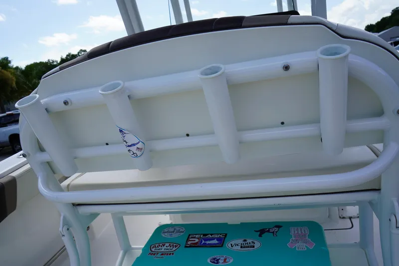 Slide: The Image of 2021 Robalo R230 Center Console boat with rod holders and sticker-covered cooler. - 11