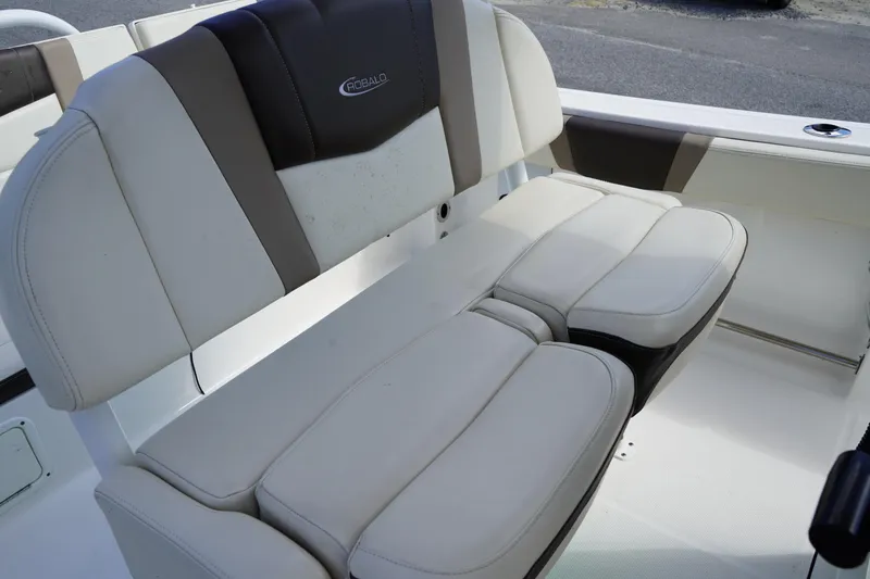 Slide: The Image of 2021 Robalo R230 Center Console boat seating, featuring cushioned white and black upholstery. - 13