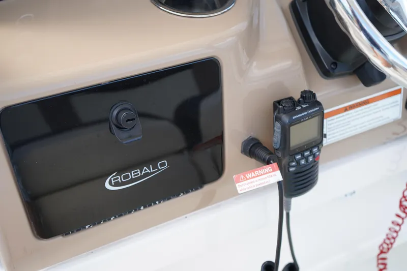 Slide: The Image of 2021 Robalo R230 Center Console dashboard with radio and warning label. - 15