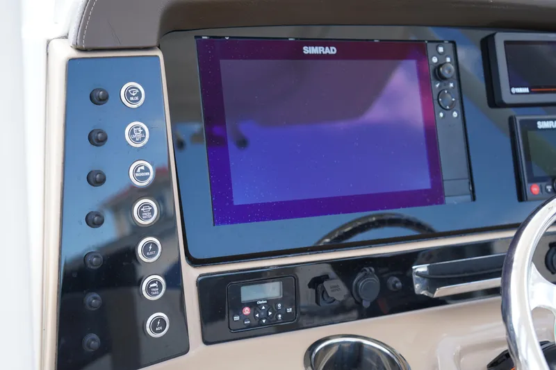 Slide: The Image of 2021 Robalo R230 Center Console dashboard with Simrad display and control buttons. - 16