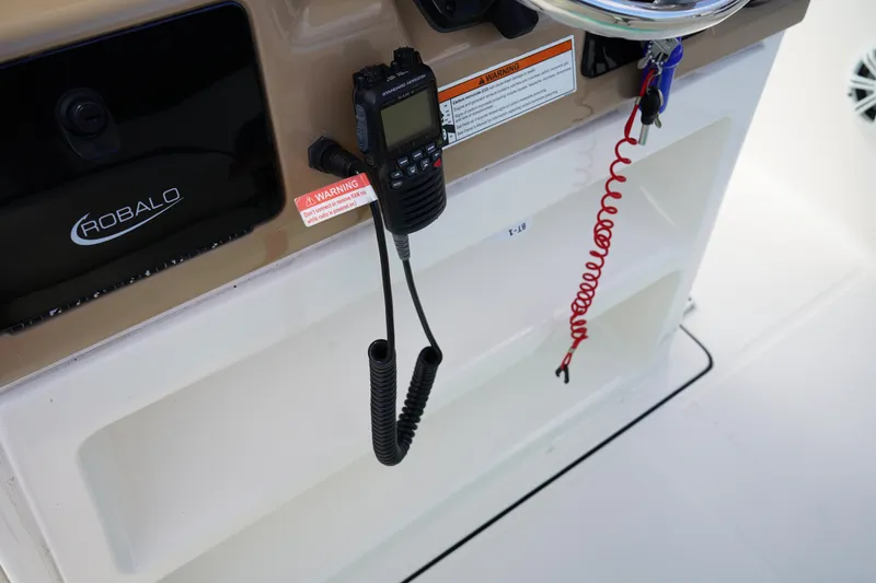 Slide: The Image of 2021 Robalo R230 Center Console dashboard with radio and safety features. - 19