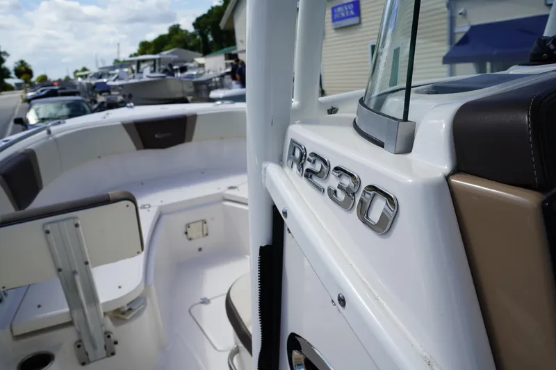 Slide: The Image of 2021 Robalo R230 Center Console boat interior with seating and console details. - 20