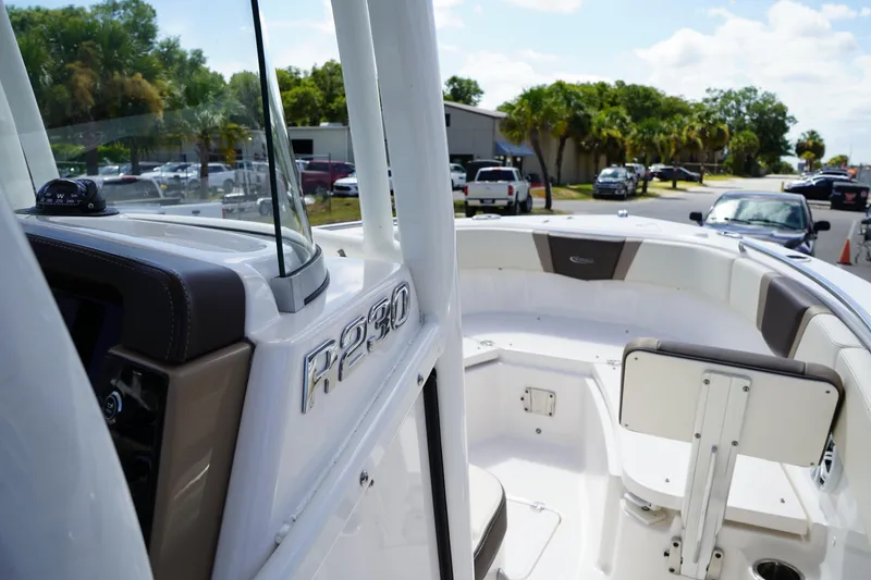 Slide: The Image of 2021 Robalo R230 Center Console boat interior with seating and console details. - 21
