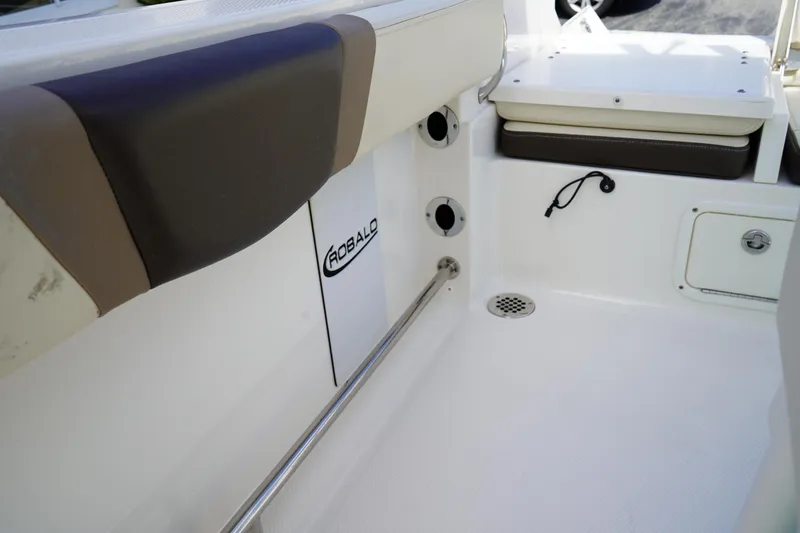 Slide: The Image of 2021 Robalo R230 Center Console interior with seating and storage features. - 22