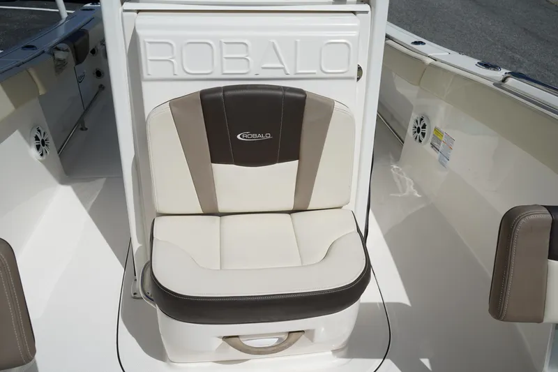 Slide: The Image of 2021 Robalo R230 Center Console boat seat, featuring beige and brown upholstery. - 25
