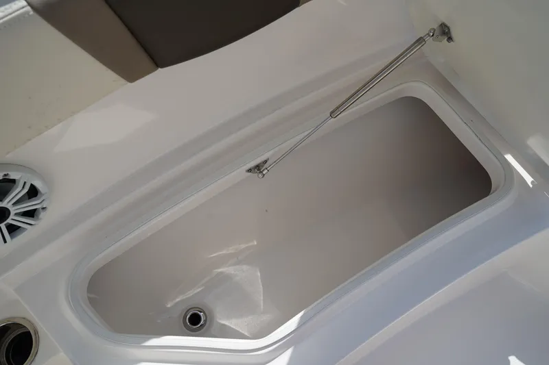 Slide: The Image of 2021 Robalo R230 Center Console storage compartment with open lid and hydraulic support. - 31
