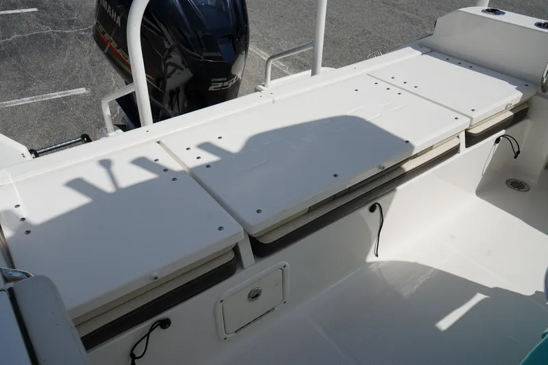 Slide: The Image of 2021 Robalo R230 Center Console boat interior with Yamaha engine, featuring storage compartments. - 5