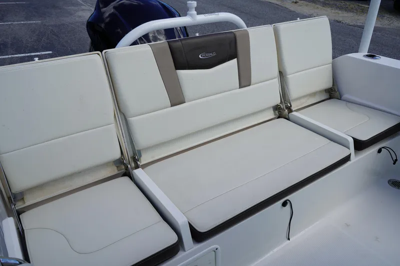 Slide: The Image of 2021 Robalo R230 Center Console boat seating, featuring white and beige cushioned seats. - 6
