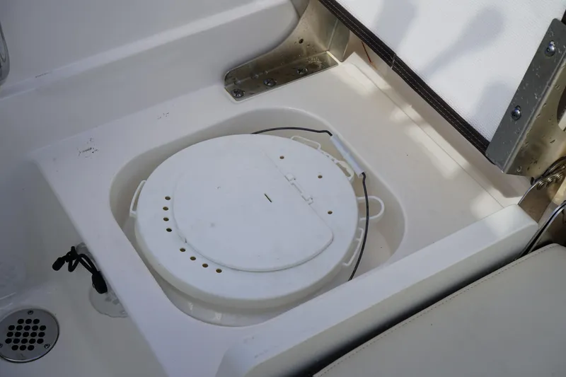 Slide: The Image of 2021 Robalo R230 Center Console boat with a built-in storage compartment. - 9