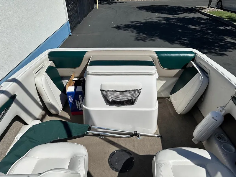 Slide: The Image of Interior of a 2001 Reinell 203 boat with green and white seating. - 13