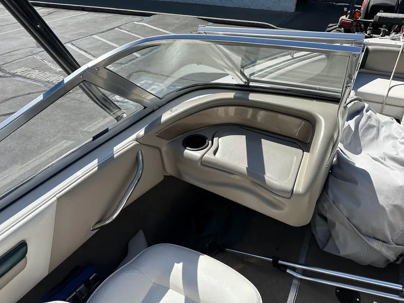 Slide: The Image of Interior of a 2001 Reinell 203 boat, featuring seating and cup holder. - 16